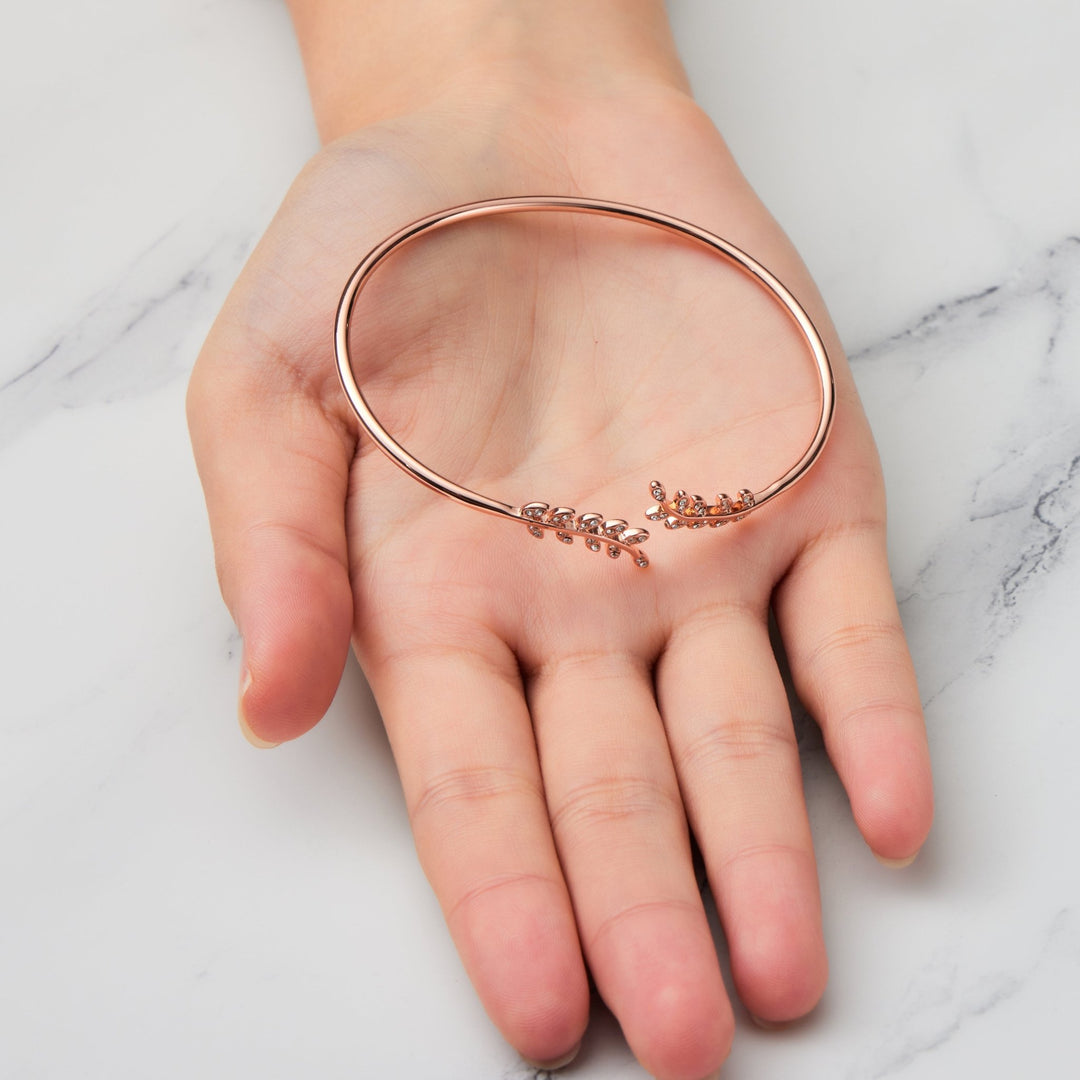 Rose Gold Plated Leaf Bangle Created with Zircondia® Crystals - Philip Jones Jewellery