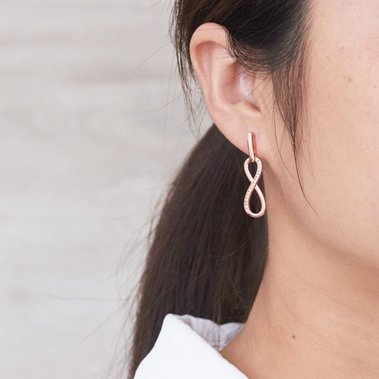 Rose Gold Plated Infinity Drop Earrings Created with Zircondia® Crystals - Philip Jones Jewellery