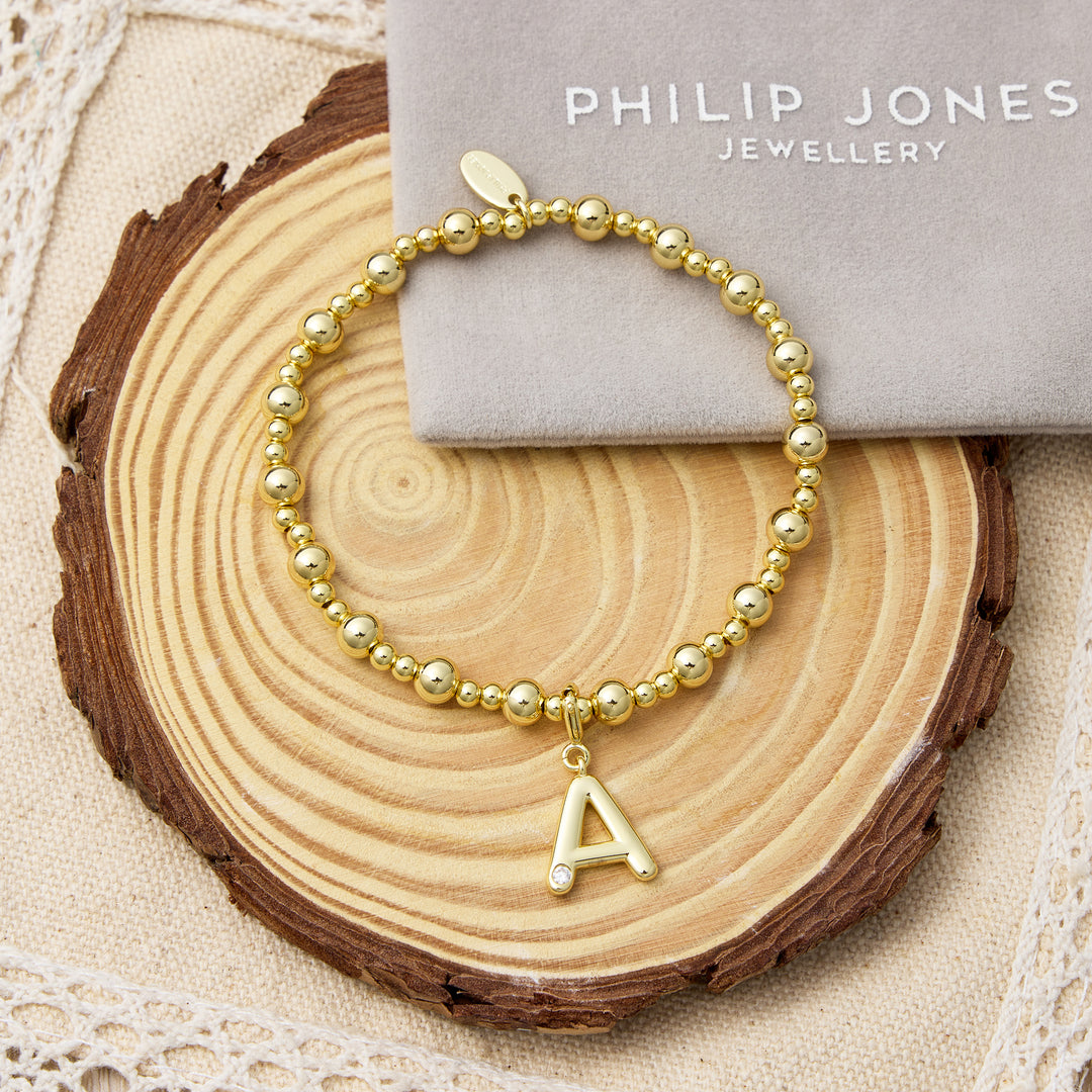 Customisable 18k Gold Plated Beaded Stretch Bracelet (A-Z) with Option of Initial Charm Lifestyle Images by Philip Jones