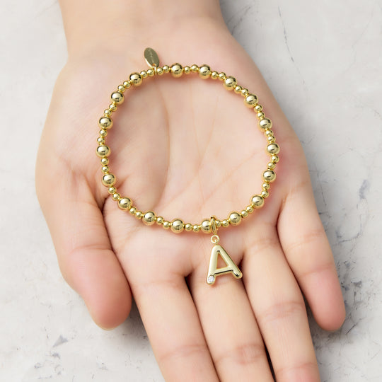Customisable 18k Gold Plated Beaded Stretch Bracelet (A-Z) with Option of Initial Charm Lifestyle Images by Philip Jones