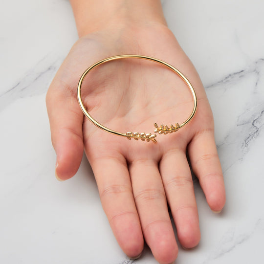 Gold Plated Leaf Bangle Created with Zircondia® Crystals - Philip Jones Jewellery
