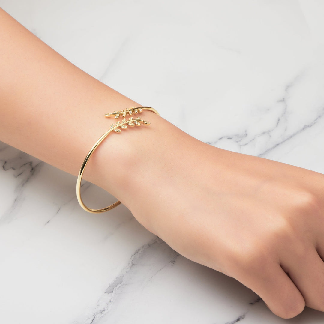 Gold Plated Leaf Bangle Created with Zircondia® Crystals - Philip Jones Jewellery