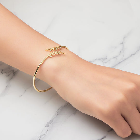 Gold Plated Leaf Bangle Created with Zircondia® Crystals - Philip Jones Jewellery