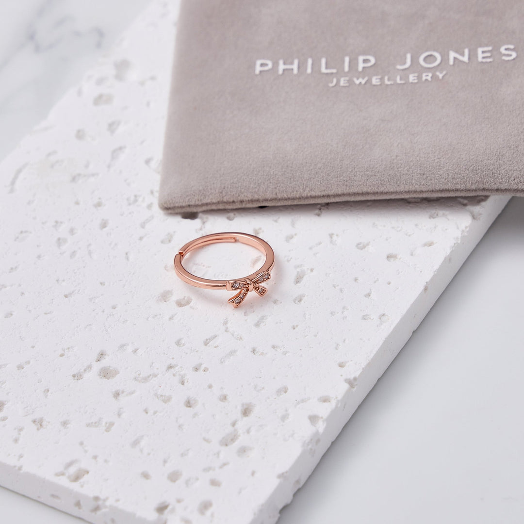 Rose Gold Plated Bow Adjustable Ring Created with Zircondia® Crystals - Philip Jones Jewellery