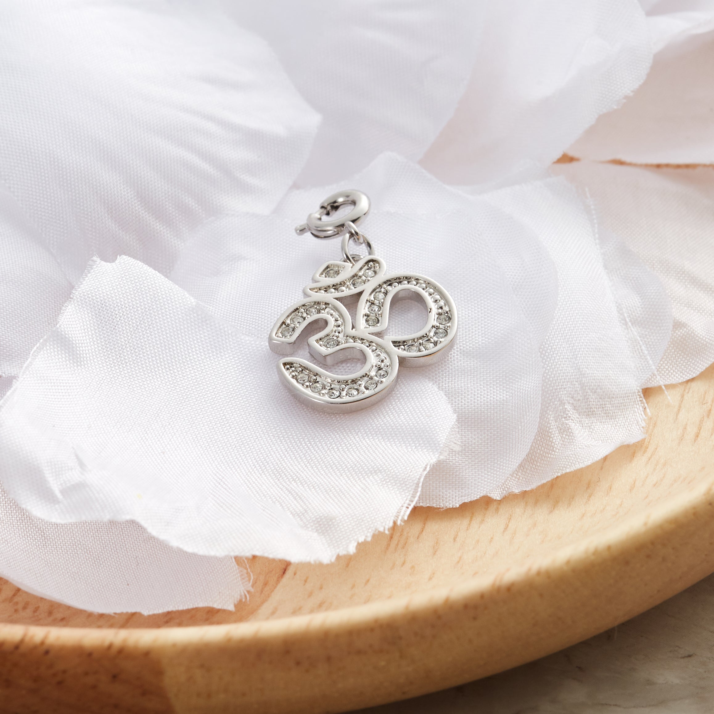 Om Charm Created with Zircondia® Crystals
