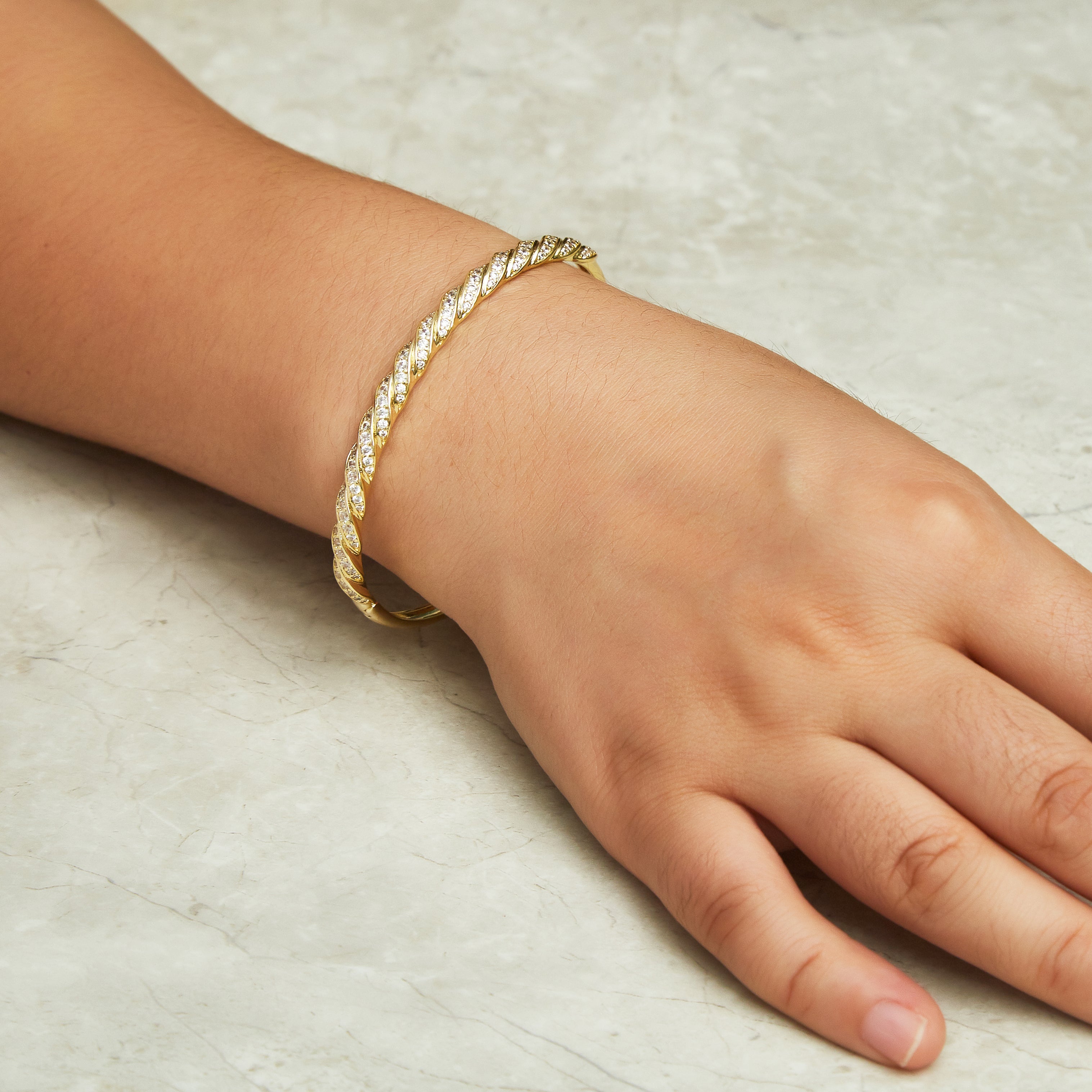 Gold Plated Twist Bangle Created with Zircondia® Crystals