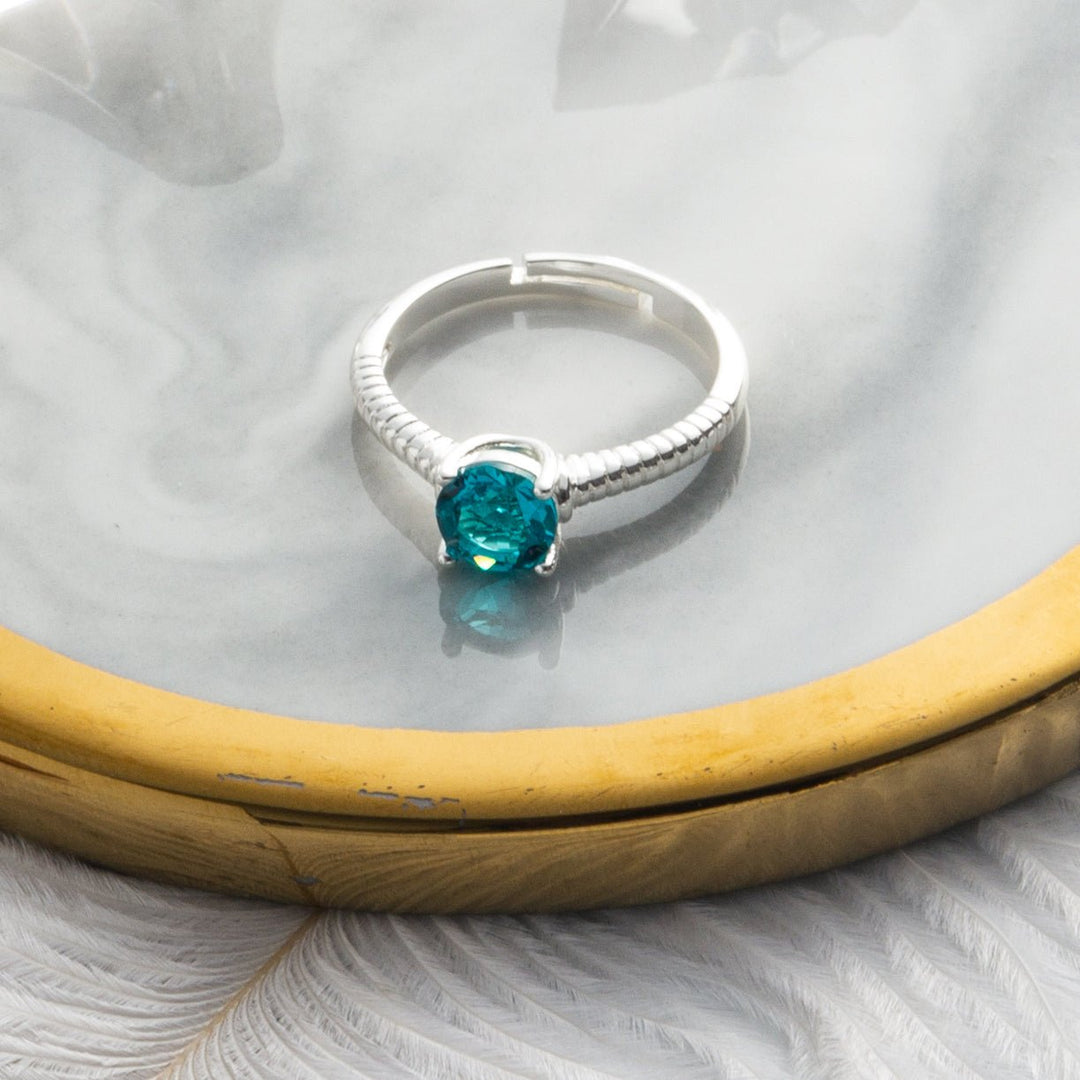 December (Blue Topaz) Adjustable Birthstone Ring Created with Zircondia® Crystals - Philip Jones Jewellery