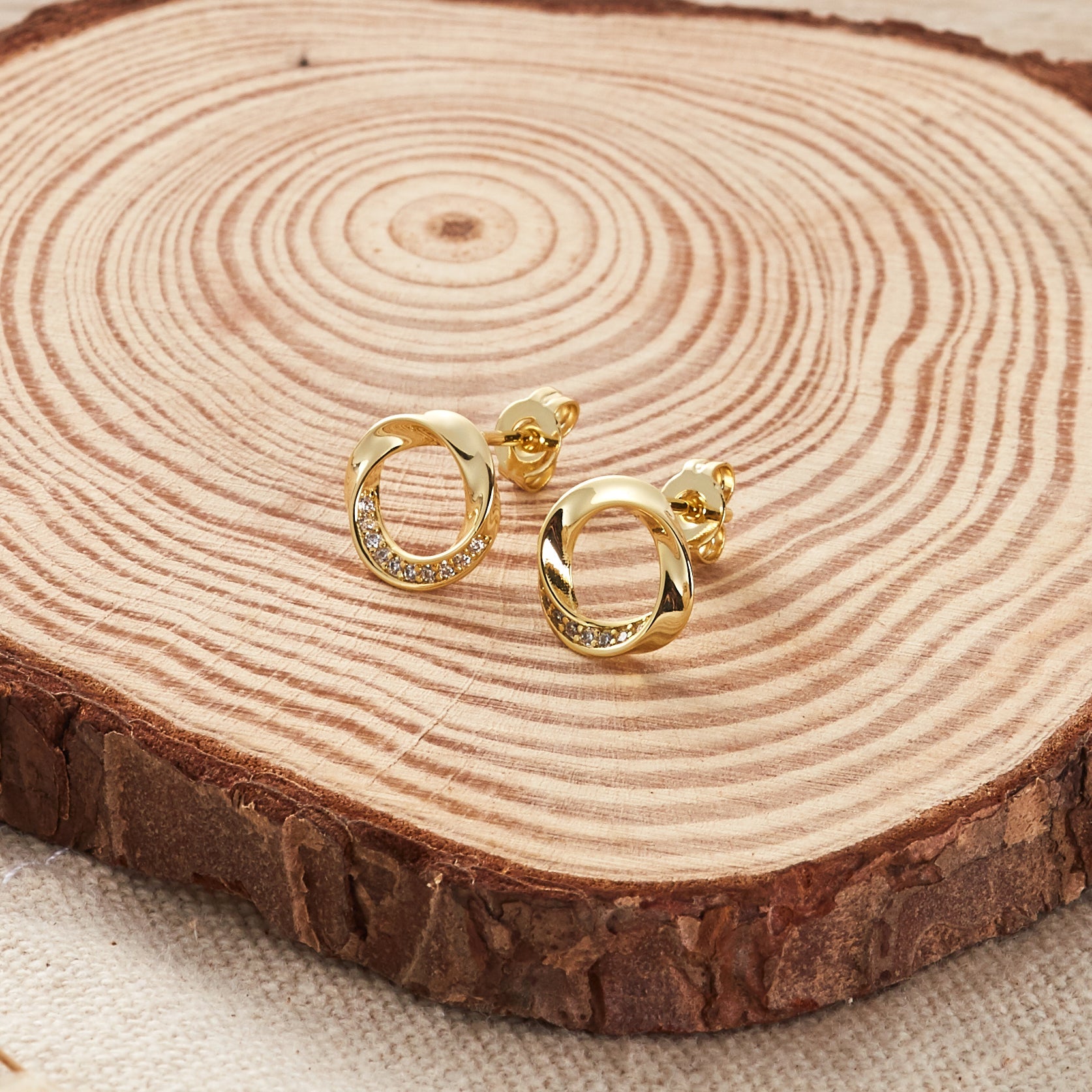 Gold Plated Circle Twist Earrings Created with Zircondia® Crystals - Philip Jones Jewellery
