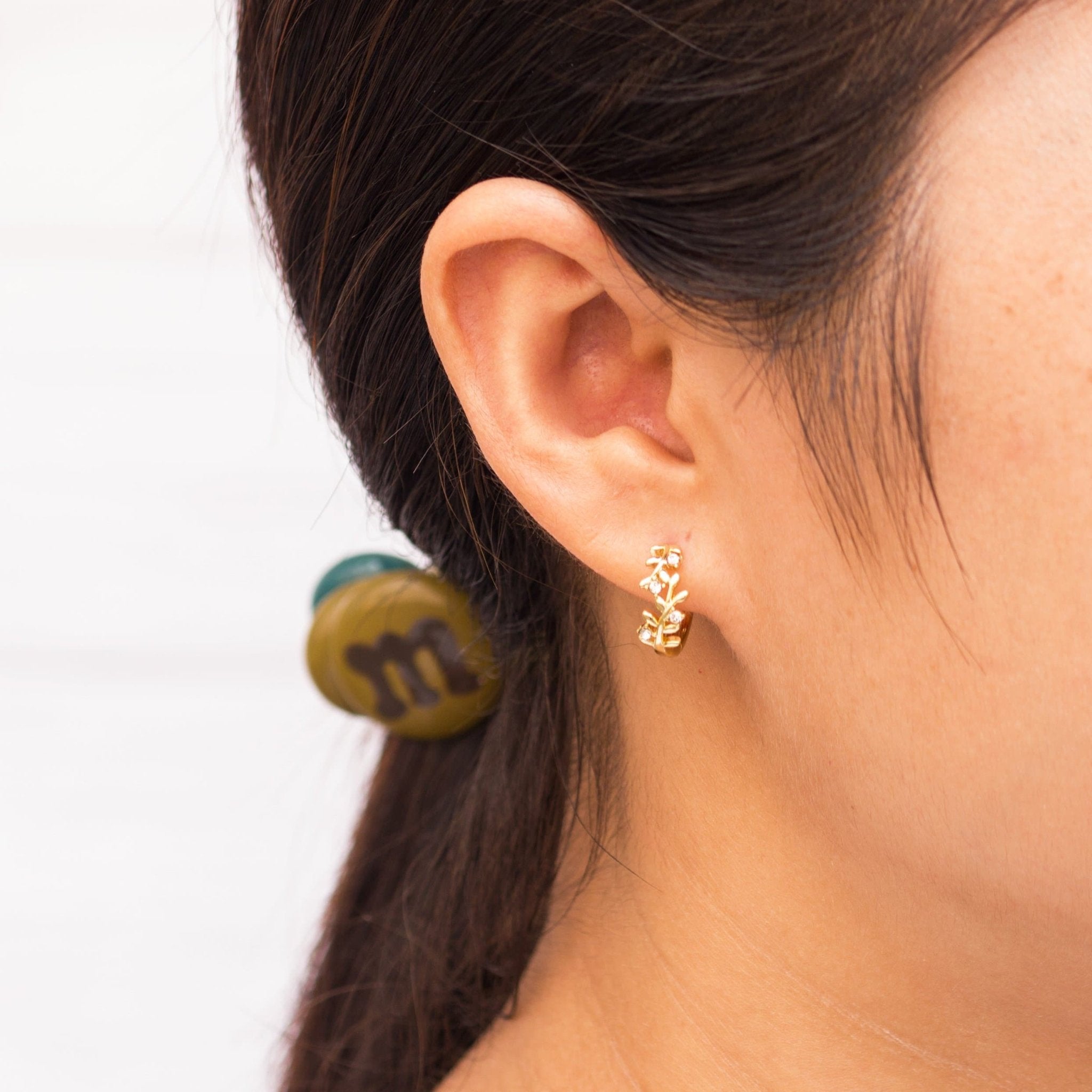 Gold Plated Leaf Hoop Earrings Created with Zircondia® Crystals - Philip Jones Jewellery