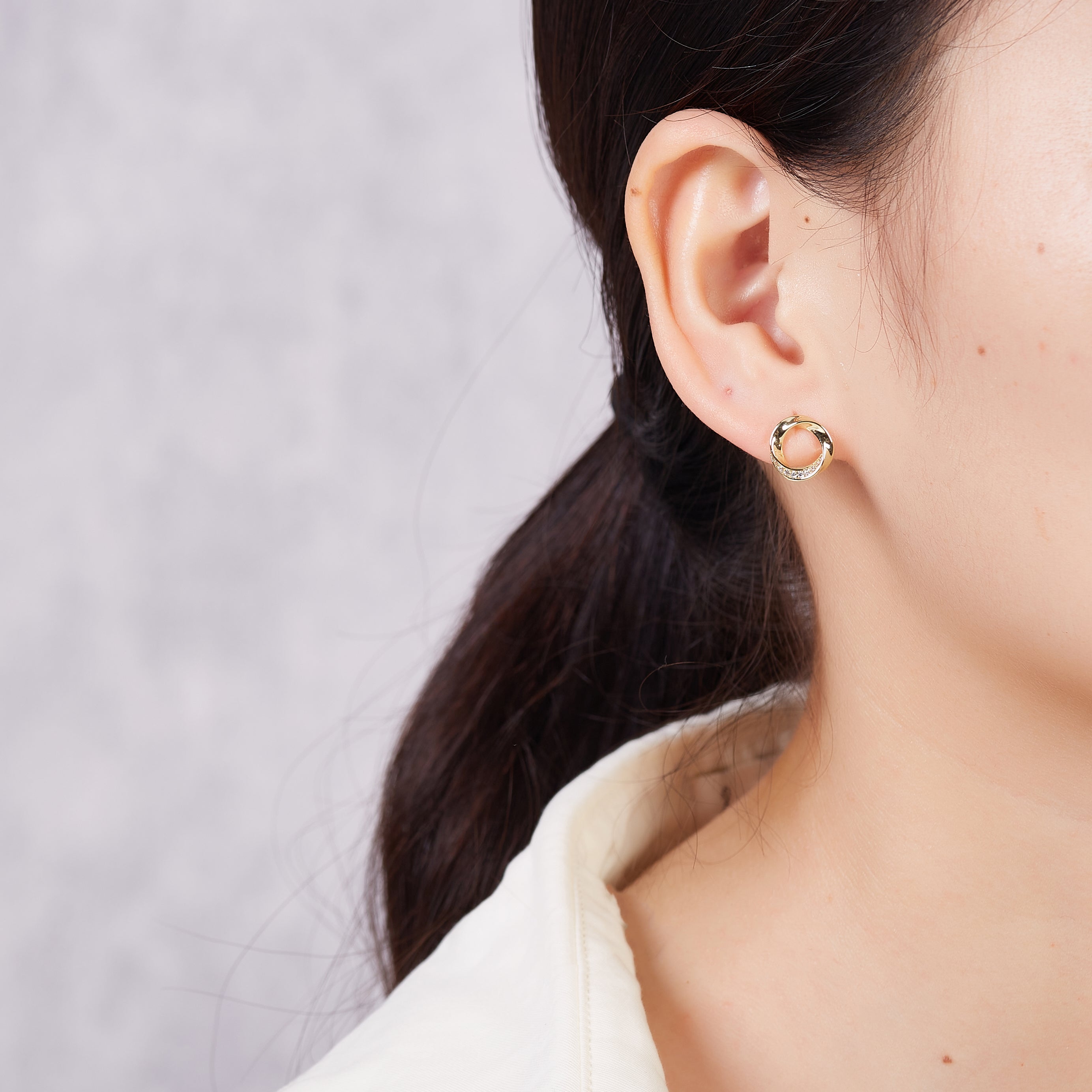 Gold Plated Circle Twist Earrings Created with Zircondia® Crystals