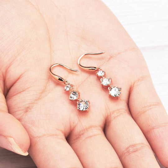 Rose Gold Plated Graduated Drop Earrings Created with Zircondia® Crystals - Philip Jones Jewellery