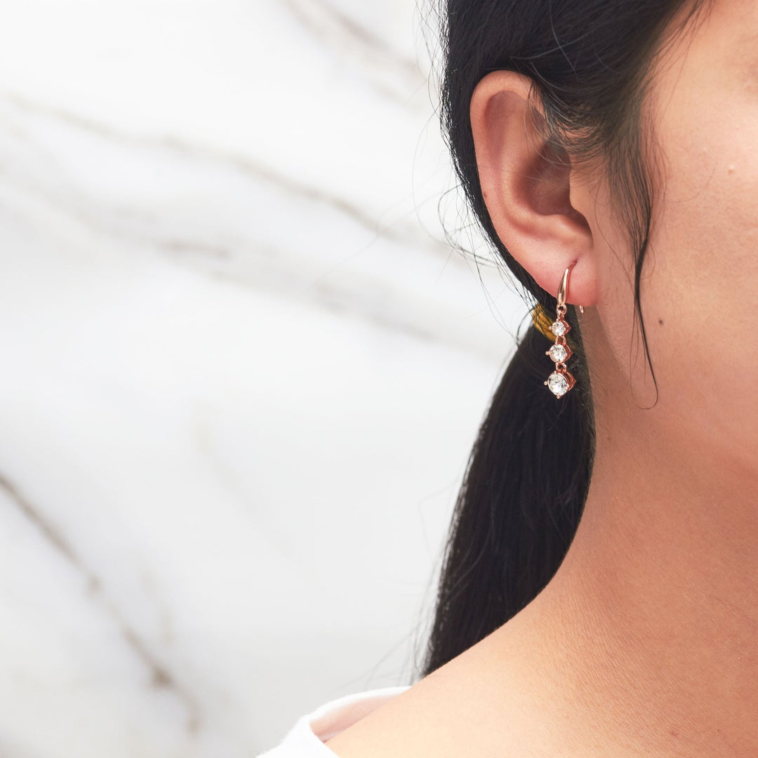 Rose Gold Plated Graduated Drop Earrings Created with Zircondia® Crystals - Philip Jones Jewellery