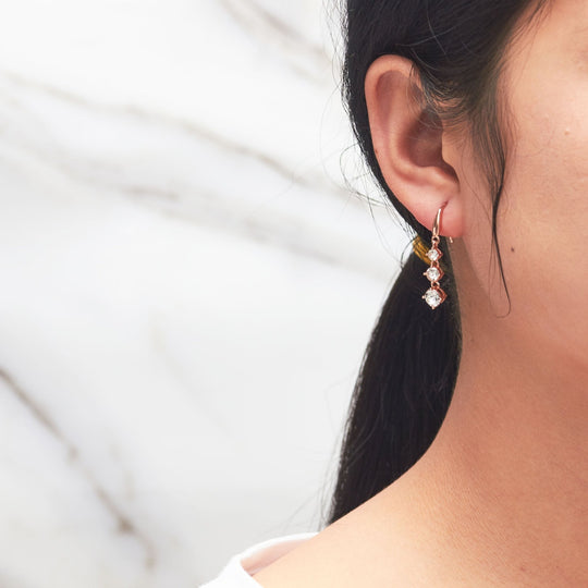Rose Gold Plated Graduated Drop Earrings Created with Zircondia® Crystals - Philip Jones Jewellery