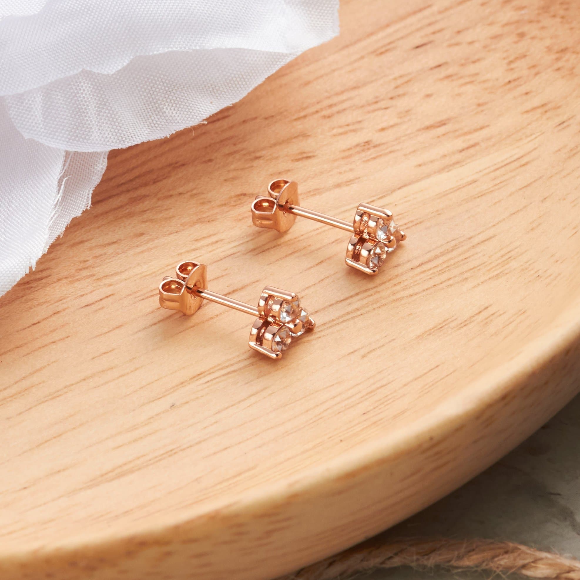 Rose Gold Plated Three Stone Earrings Created with Zircondia® Crystals - Philip Jones Jewellery